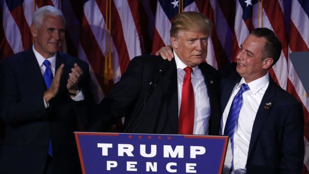 US President-elect Donald Trump is embraced by Reince Priebus, chairman of the Republican National Committee, after the shock election win as Vice-President-elect Mike Pence looks on.