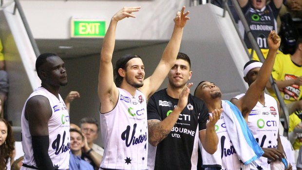 Melbourne United players Majok Majok, Chris Goulding, Chris Patton and Stephen Holt celebrate a late three-pointer in their win over Cairns Taipans.