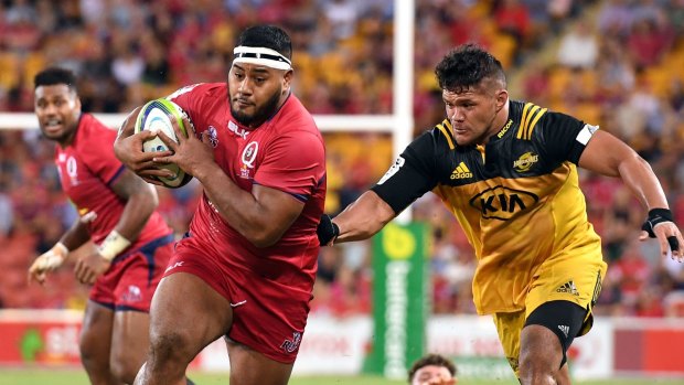 Trail of destruction: Taniela Tupou charges through the Hurricanes defence for the Queensland Reds.