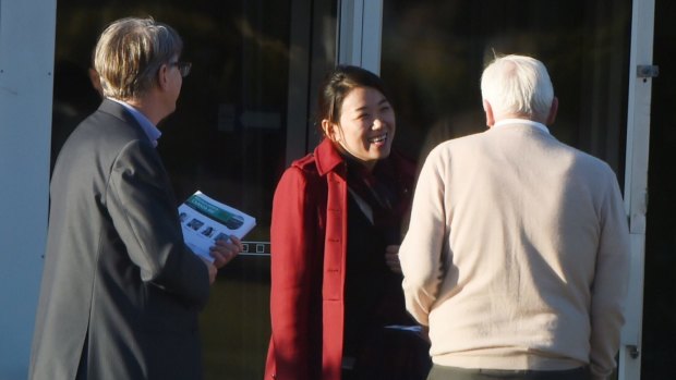 Yuehan Zhang (centre) and Andrew Ferguson (left) greet members as they arrive at the preselection vote for Labor's Canada Bay council ticket on Wednesday. 