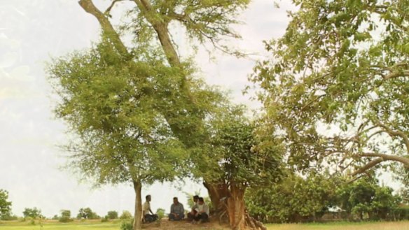 Bunhom Chhorn and his childhood friend sit under the tamarind tree in Camp 32 talking about what they saw there 40 years ago.