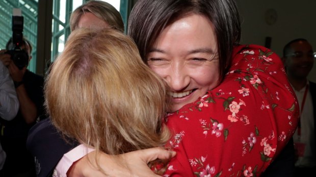 Magda Szubanski embraces Senator Penny Wong after the vote on the Marriage Amendment Bill at Parliament House in Canberra on Thursday 7 December 2017. 