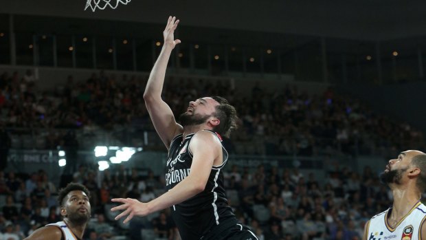 Melbourne United's Peter Hooley lays up against the  Sydney Kings.