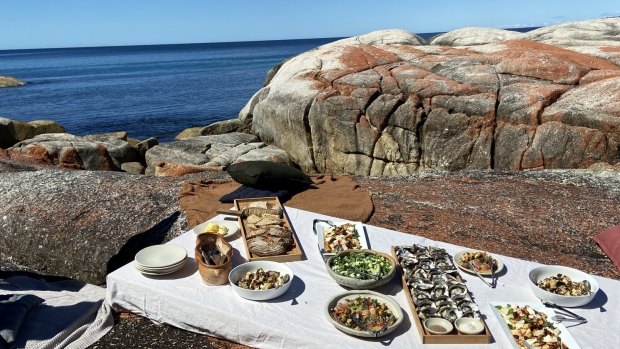 Lunch on the rocks at Tasmania's Bay of Fires with Blue Derby Pods Ride.
