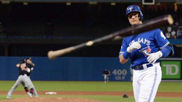 A disappointed Troy Tulowitzki throws his bat after the Indians win.
