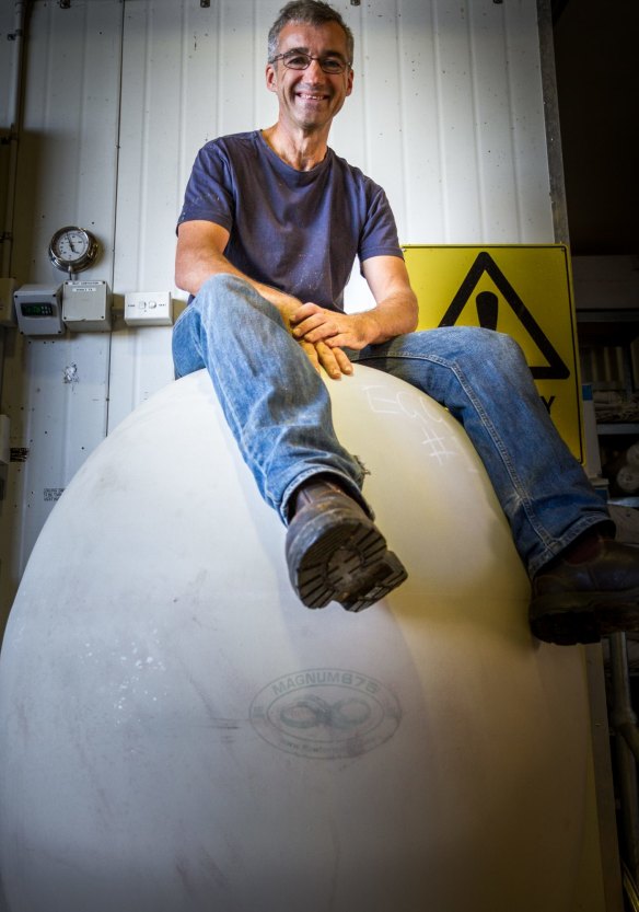 Bryan Martin sitting on an egg 