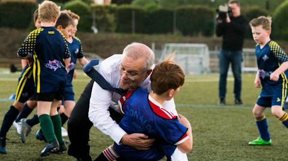 The Prime Minister accidentally bowls over a child when playing with the Devonport Strikers on Wednesday.