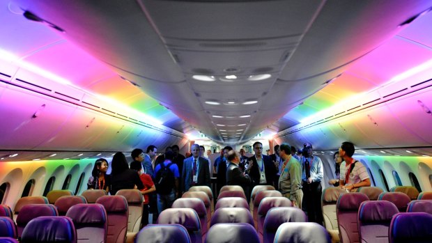 Press members tour the Boeing 787 Dreamliner's cabin with its versatile LED lighting system. 