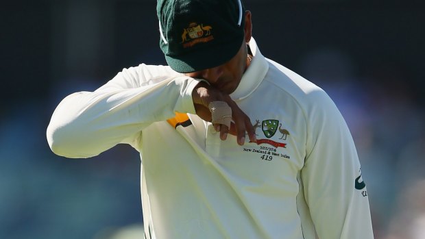 Out of action: Usman Khawaja of Australia leaves the ground with an injury.