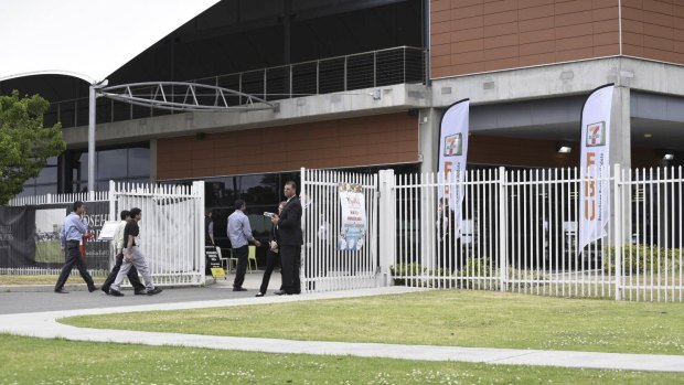 Franchisees arrive for a meeting with 7-Eleven  management at Rosehill Gardens in Sydney on Thursday. 