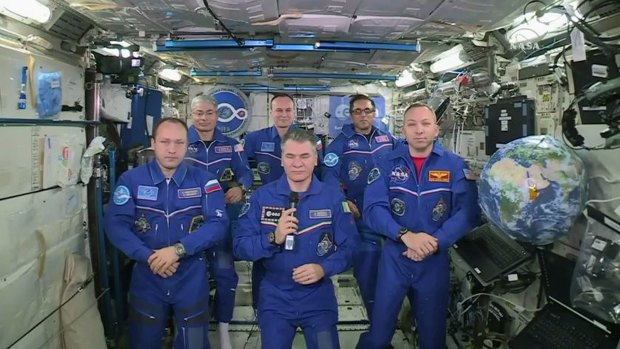 Italian astronaut Paolo Nespoli, centre, and his fellow crew members speak to the Pope from the International Space Station on Thursday.