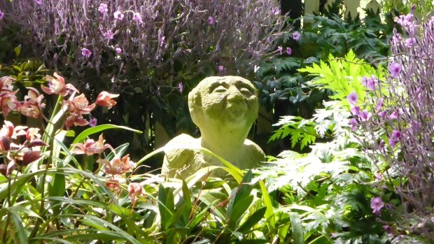 A limestone sculpture of the patron saint of gardening, St Fiacre, in Frances Henke's garden.