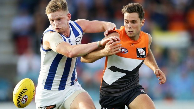 The Giants' Josh Kelly and Jack Ziebell, of the Kangaroos, compete for the ball in a pre-season match.