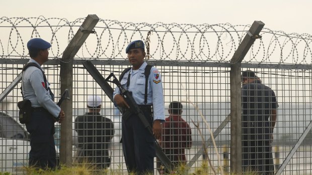 Indonesian police and security guard the fence line at Ngurah Rai International airport when Bali Nine duo Myuran Sukumaran and Andrew Chan were transferred Nusakambangan.