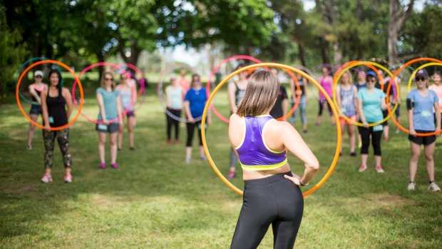 Spin Joy owner Caitlin Woods teaches hula hooping to adults and children.