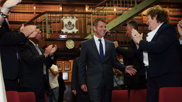 NSW Premier Mike Baird is congratulated as he enters a party room meeting of the NSW Liberal Party on Wednesday.