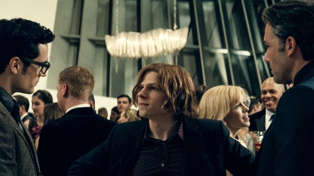 Jesse Eisenberg as Lex Luthor greets Superman (Henry Cavill) and Batman (Ben Affleck).