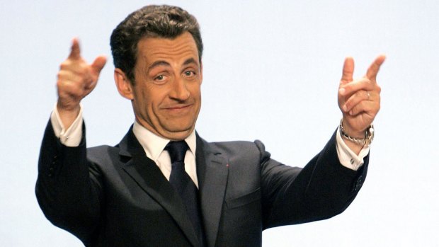 ** CORRECTS TRANSREF TO LON103 ** FILE ** French President elect Nicolas Sarkozy gestures to supporters at the Gaveau concert hall in Paris, in this Sunday, May 6, 2007 file photo. Just 10 months after his election, French President Nicolas Sarkozy is giving himself an image makeover, trading in his flashy, in-your-face style for a more dignified demeanor. Newspapers nicknamed Sarkozy the "bling-bling president" because of his affinity for Rolexes, private yachts and putting his love life on display. But with his approval ratings dropping, and after voters punished him by snubbing his conservative party in local elections, Sarkozy spent the past week trying to look more presidential. (AP Photo/Christophe Ena/file)