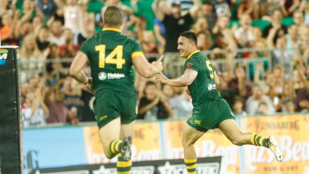 Unstoppable: Valentine Holmes races away for one of his record five tries against Samoa.
