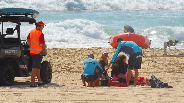 NSW Surf Lifeguards and Surf Rescue assist Tui Gallaher's mother.
