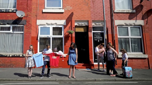Residents in Manchester observe a minutes silence in memory of the victims of the Manchester bomb attack.