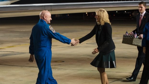 Jill Biden, the wife of Vice-President Biden, greets Expedition 46 Commander Scott Kelly of NASA.