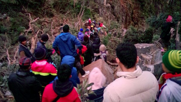 Climbers trek down the Timpohan Trail with the help of local mountain guides on Mount Kinabalu in eastern Sabah state on Borneo, Malaysia, after the 4,095-metre-high mountain was struck by a strong earthquake. 
