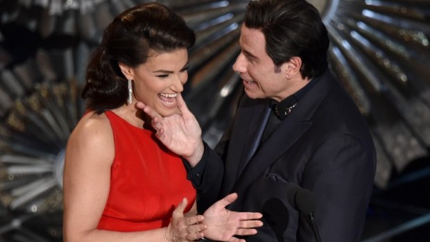 Awkward: Idina Menzel, left, and John Travolta present the award for best original song at the Oscars at the Dolby Theatre in Los Angeles.