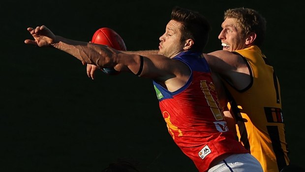 Stefan Martin of the Lions and Ben McEvoy of the Hawks compete for the ball.