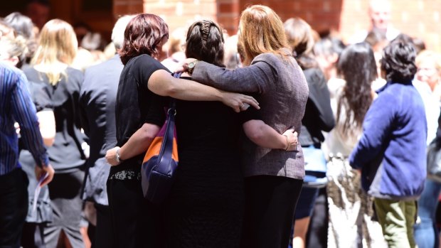 Family and friends gather after the funeral of Fernando Mantique, 44, Maria Claudia Lutz, 43, Ellie, 11 and Martin, 10, at the Holy Name Catholic Church in Wahroonga.