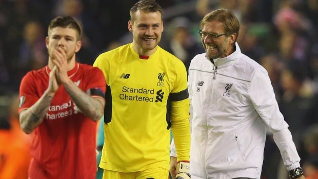 All smiles: Jurgen Klopp (right) jokes with Simon Mignolet after the final whistle.