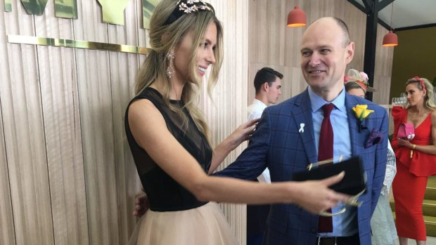 Partying as the enemy arrived: Myer CEO Richard Umbers with Jennifer Hawkins on Cup Day.