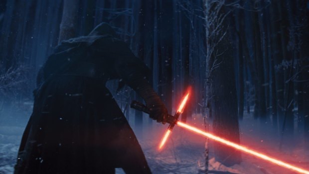 Kylo Ren wields his lightsaber in <i>Star Wars: The Force Awakens</i>.