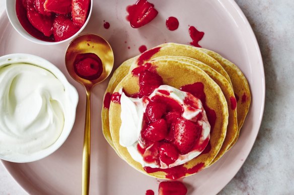 Pancakes with juicy berries and whipped cream.