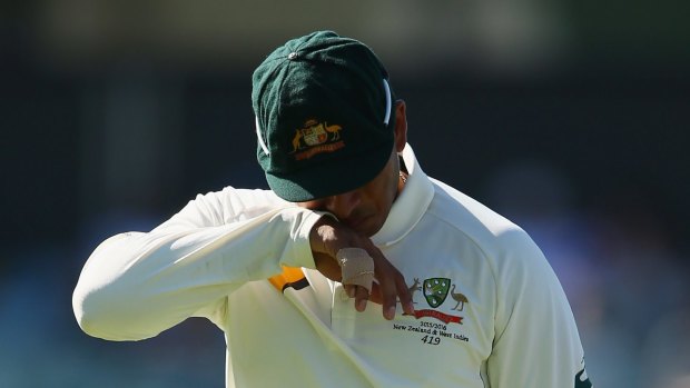 Out of action: Usman Khawaja departs after being injured during the second Test.