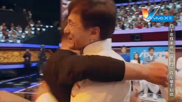 Jackie Chan greeted by his stuntman ''brother'' at recent tribute.