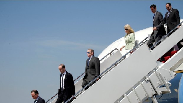 Under fire: Members of Donald Trump's staff disembark from Air Force One upon the President's arrival at Joint Base Andrews in Maryland on Wednesday. 