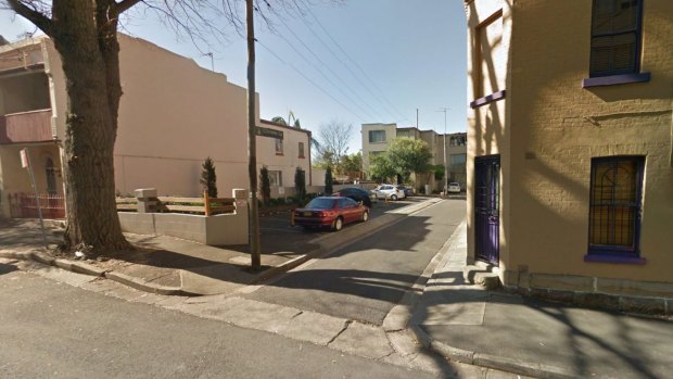 The woman was allegedly dragged behind a car in Christie Lane, Surry Hills.