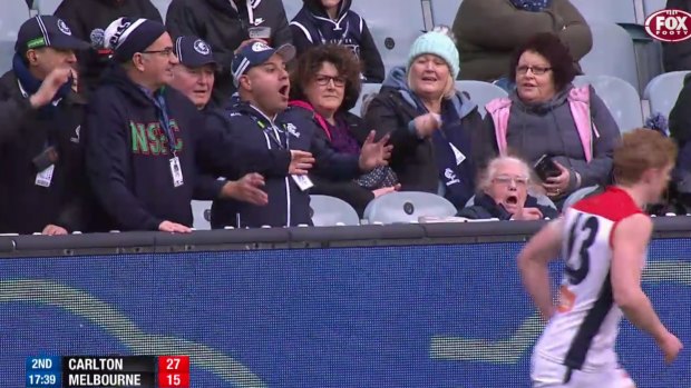 Clayton Oliver walks away after arguing with a Carlton fan in the match at the MCG on Sunday. 