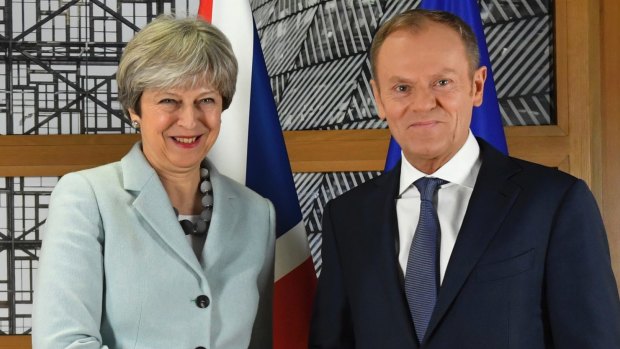 British PM Theresa May walks with European Council President Donald Tusk prior to a meeting at the Europa building in Brussels.