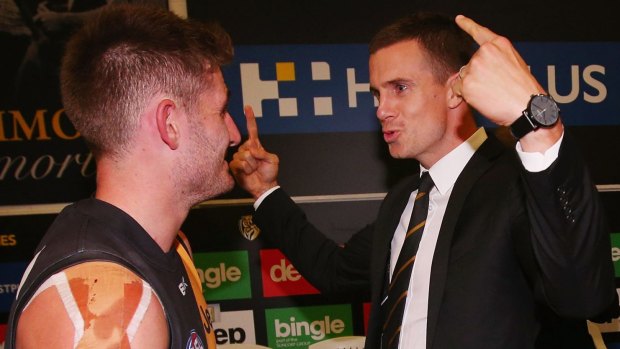 Brett Deledio of the Tigers (right) has a word with teammate Anthony Miles after the game.