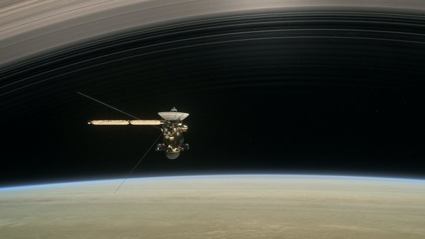 A still from a short film <em>Cassini's Grand Finale</em>, shows the spacecraft diving between Saturn and the planet's innermost ring.