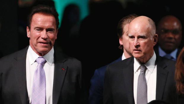 California Governor Jerry Brown, right, and Arnold Schwarzenegger arrive at One Planet Summit, near Paris, On December 12. 