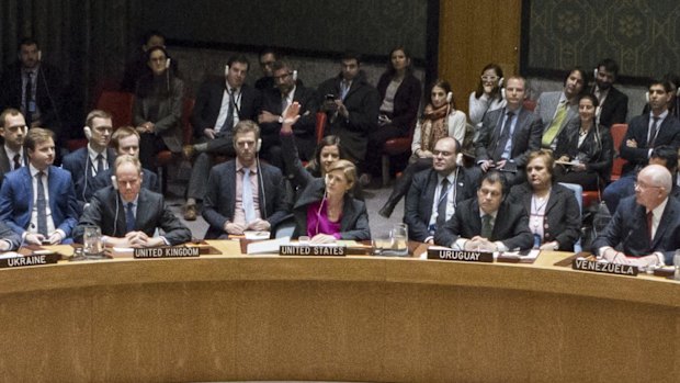 US ambassador to the UN Samantha Power, centre, raises her hand to abstain during the UN Security Council vote on 23 December.