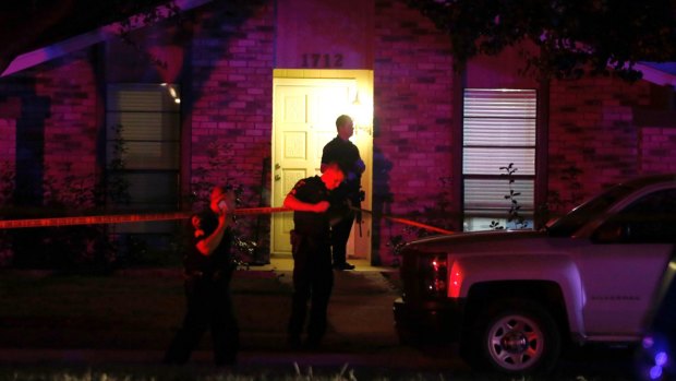 Police officers work the scene of a shooting at a home in Plano, north of Dallas, Texas.