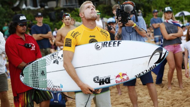 Mick Fanning looks to the sky before competing in the Pipe Masters in Hawaii, shortly after learning of his brother Peter's death. 