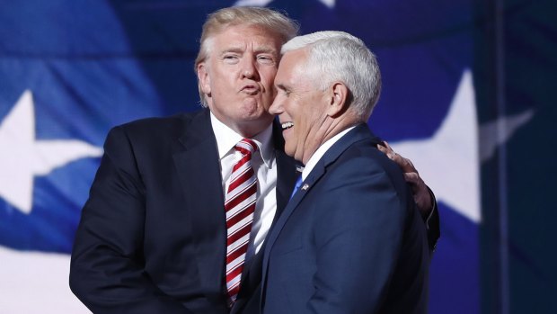 Republican presidential candidate Donald Trump kisses his nominated veep Indiana Governor Mike Pence.