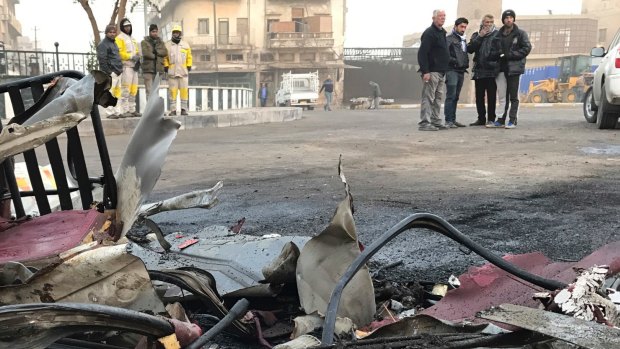 People inspect the aftermath of a car bomb in Baghdad on December 4.