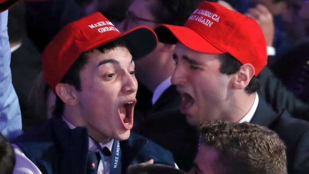 Supporters of Donald Trump react as they watch the US election results roll in.