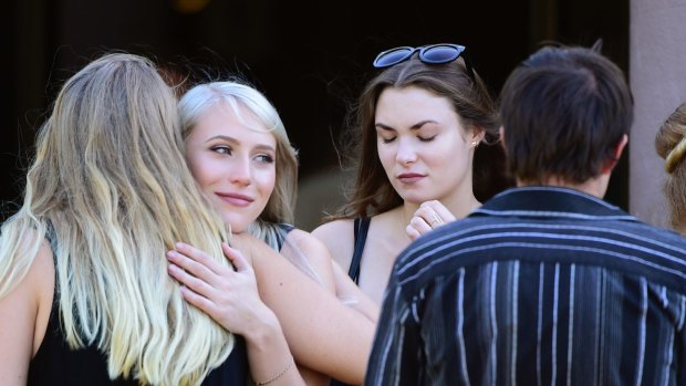 Zahra - Michael Chamberlain's daughter with second wife Ingrid - leaves his memorial service.
